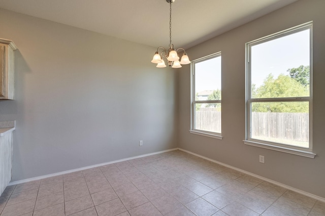 unfurnished dining area featuring light tile patterned floors and an inviting chandelier