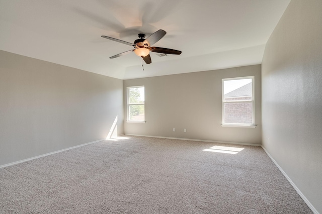 carpeted spare room with ceiling fan