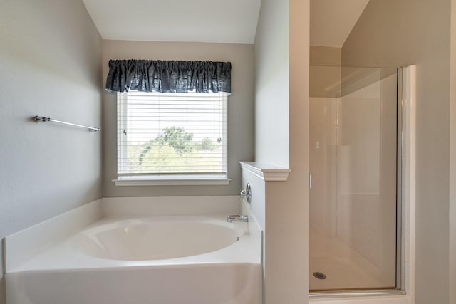 bathroom featuring shower with separate bathtub