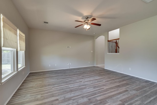 spare room with hardwood / wood-style floors and ceiling fan