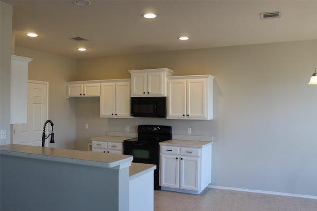 kitchen with white cabinetry, sink, black appliances, and kitchen peninsula