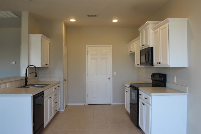 kitchen featuring white cabinetry, sink, and black appliances