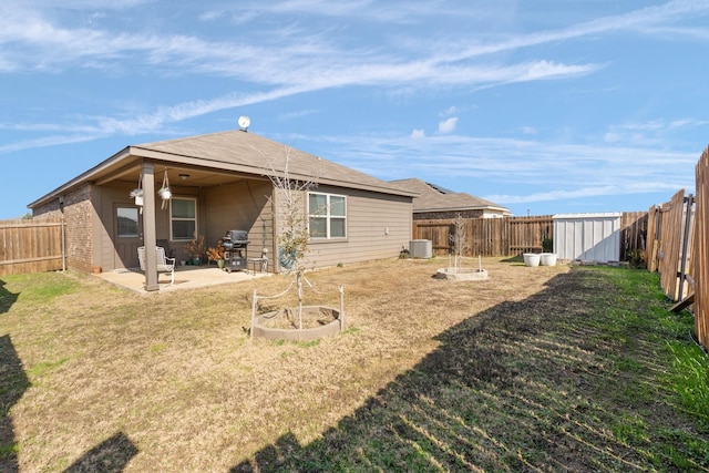 back of property with cooling unit, a yard, a patio area, and a shed