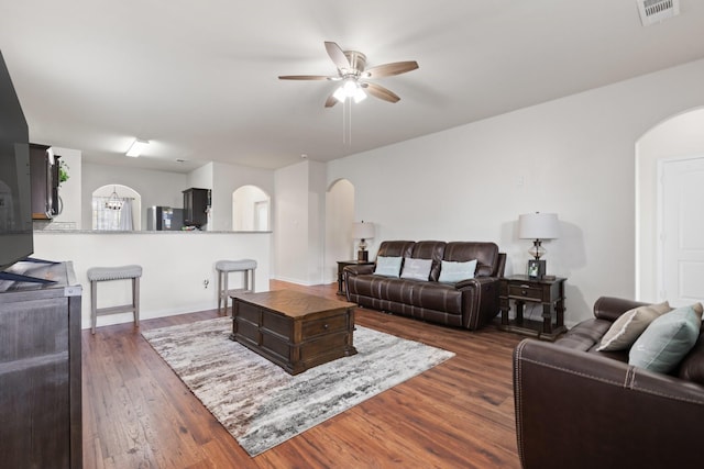 living room featuring dark hardwood / wood-style floors and ceiling fan