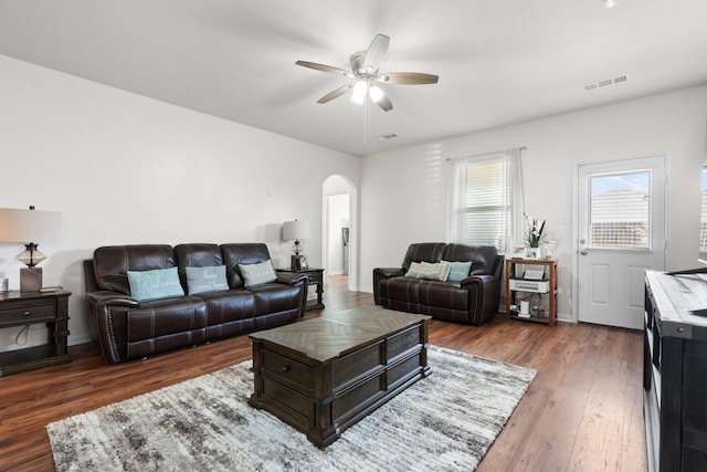 living room with dark wood-type flooring and ceiling fan