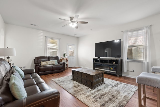 living room featuring hardwood / wood-style flooring and ceiling fan