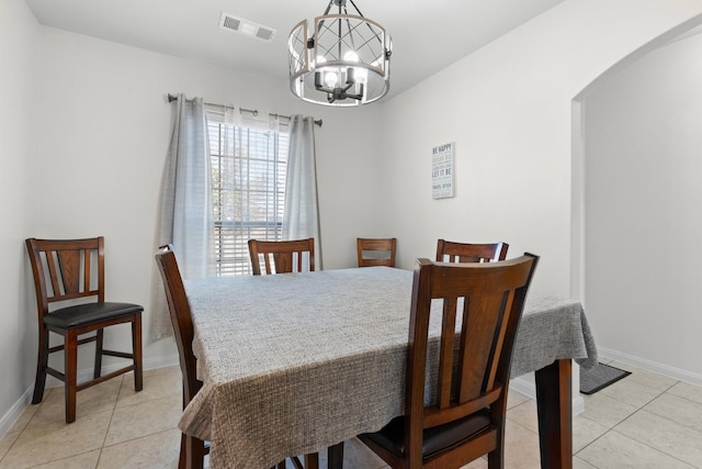 dining space with light tile patterned flooring and a chandelier