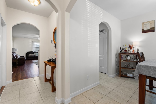 hall with light tile patterned floors