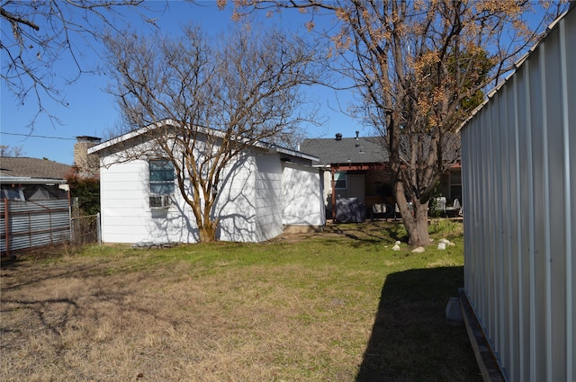 back of house featuring a lawn