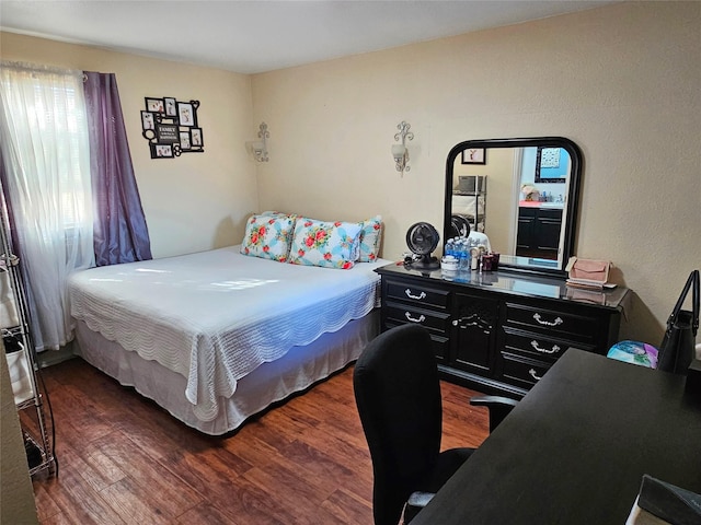 bedroom with dark hardwood / wood-style floors