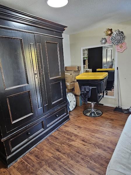 interior space with wood-type flooring and a textured ceiling