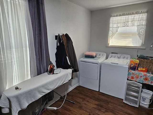 washroom featuring dark hardwood / wood-style floors and washing machine and dryer