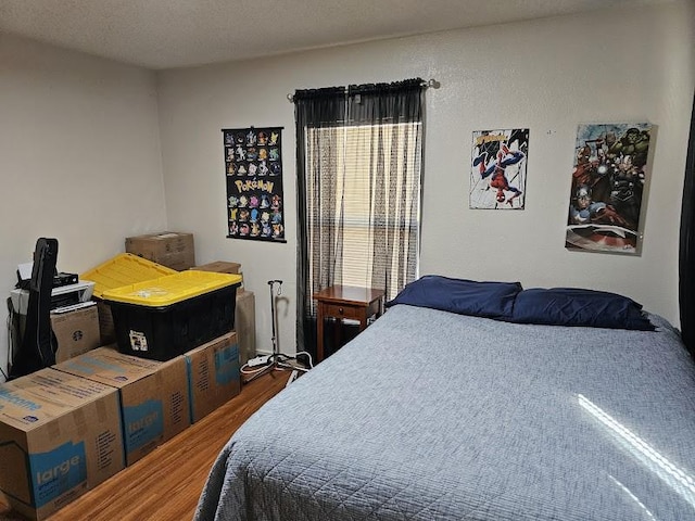 bedroom with hardwood / wood-style flooring