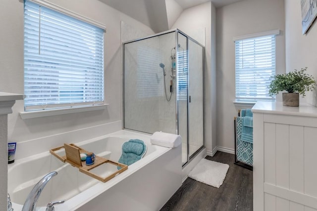 bathroom featuring hardwood / wood-style flooring and shower with separate bathtub