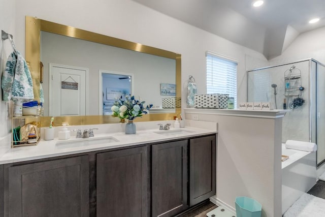 bathroom featuring vanity, lofted ceiling, and shower with separate bathtub