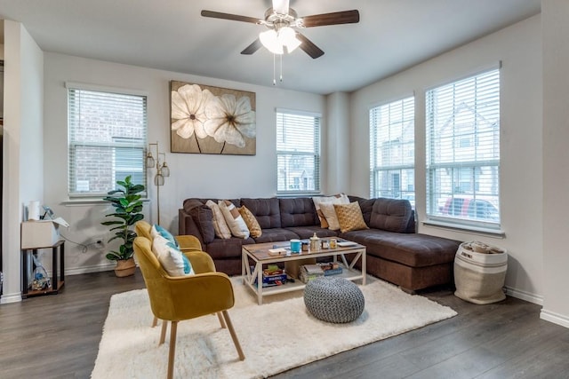 living room with dark hardwood / wood-style flooring and ceiling fan