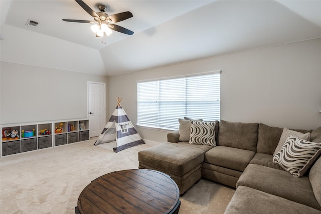 living room featuring carpet floors, ceiling fan, and vaulted ceiling