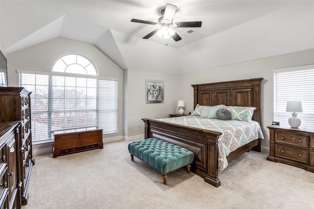 carpeted bedroom with ceiling fan and vaulted ceiling