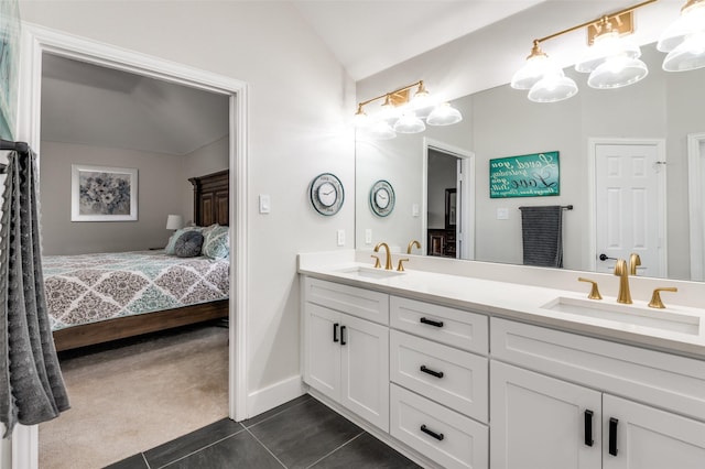 bathroom with vanity, vaulted ceiling, and tile patterned floors