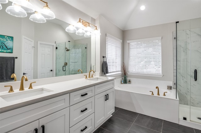 bathroom featuring tile patterned flooring, vaulted ceiling, vanity, and plus walk in shower