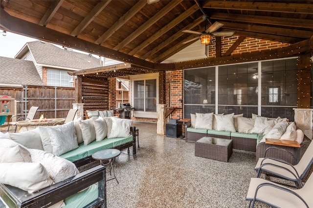 view of patio / terrace with an outdoor living space with a fire pit and ceiling fan