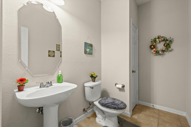 bathroom featuring tile patterned floors and toilet