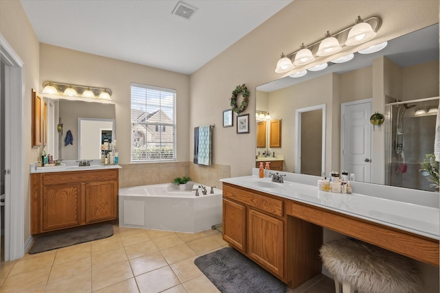 bathroom with tile patterned floors, shower with separate bathtub, and vanity