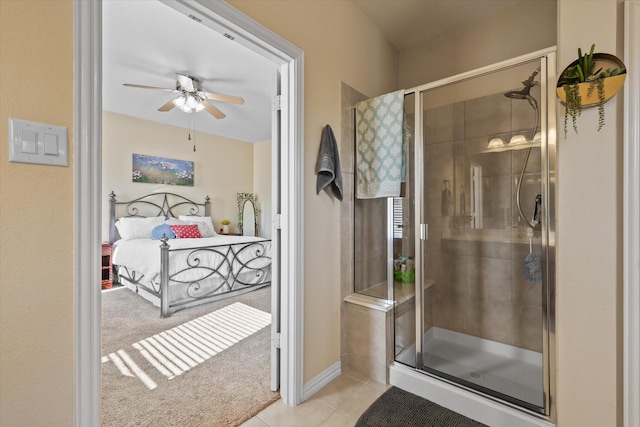 bathroom with walk in shower, ceiling fan, and tile patterned flooring