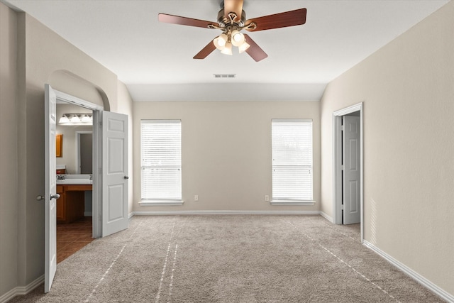 unfurnished bedroom with lofted ceiling, light colored carpet, and ceiling fan