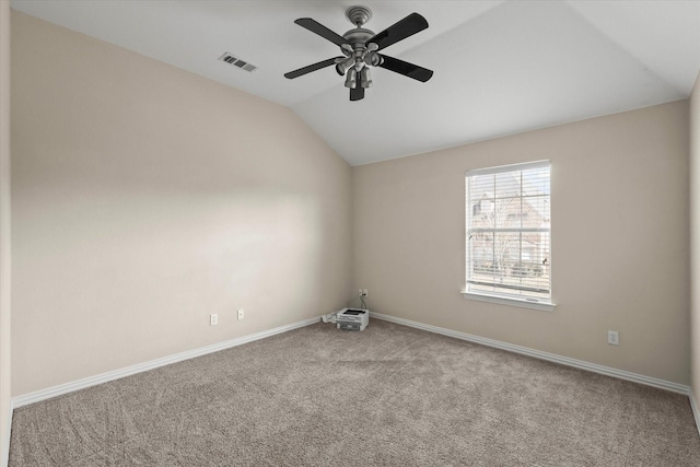 carpeted empty room with vaulted ceiling and ceiling fan