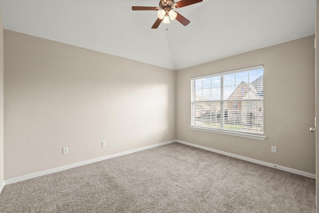 empty room with lofted ceiling, ceiling fan, and carpet