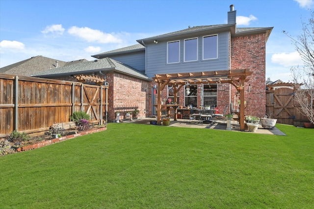 back of house with a yard, a pergola, and a patio area