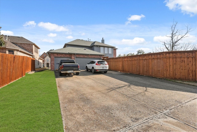 view of home's exterior with a garage and a yard