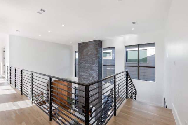 staircase with hardwood / wood-style flooring