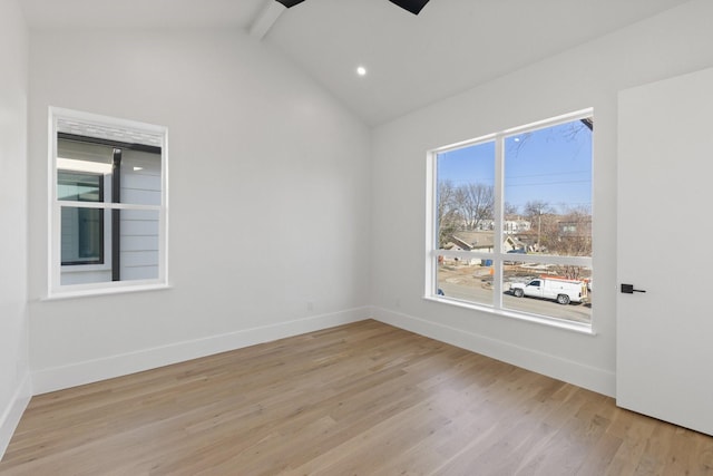 spare room with vaulted ceiling with beams, light hardwood / wood-style flooring, and ceiling fan