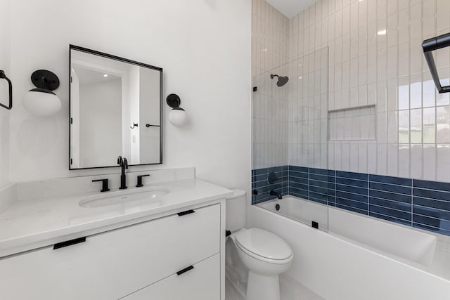 full bathroom with tiled shower / bath, vanity, and toilet