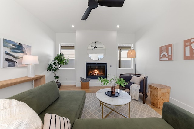 living room with ceiling fan and light hardwood / wood-style flooring