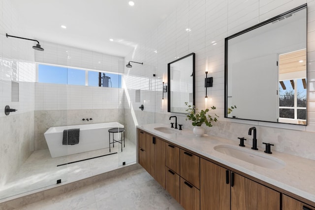 bathroom featuring tile walls, vanity, tile patterned flooring, and separate shower and tub