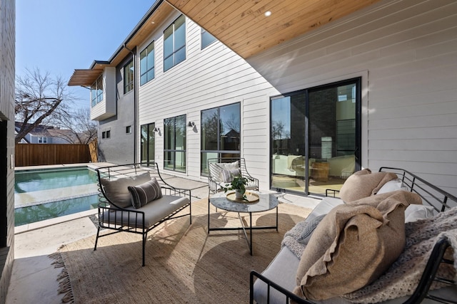 exterior space featuring an outdoor hangout area and a fenced in pool