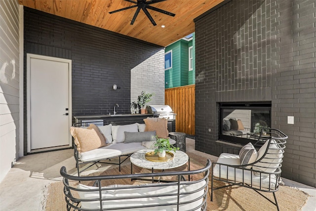 view of patio featuring a grill, sink, an outdoor living space with a fireplace, and ceiling fan