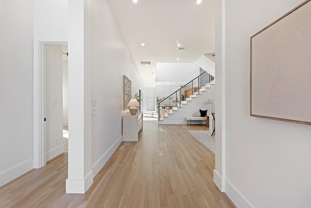 hallway with light hardwood / wood-style floors