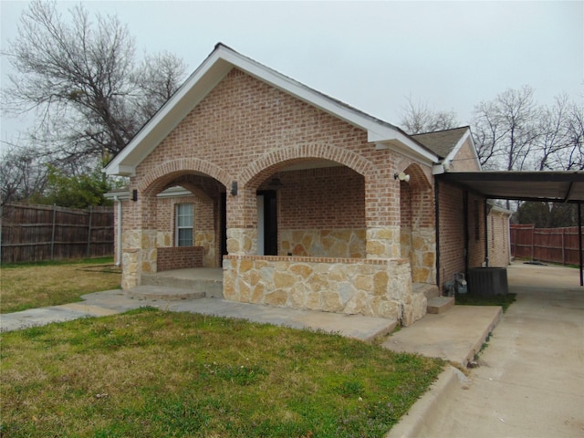 view of front facade with a carport and a front lawn