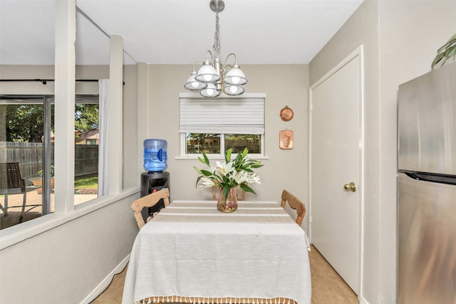 tiled dining room with a wealth of natural light and a notable chandelier