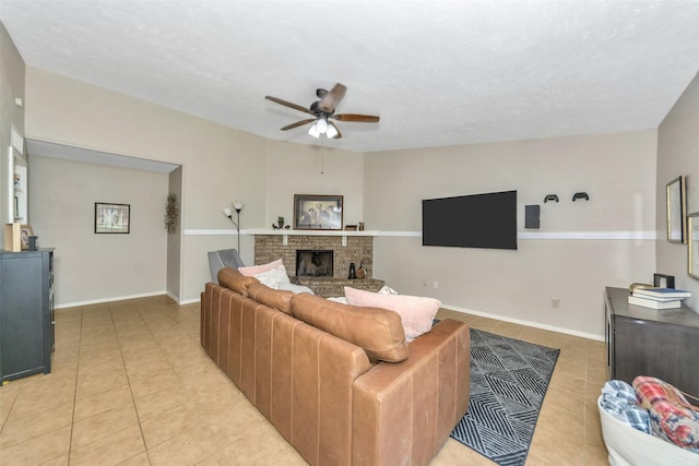 living room featuring light tile patterned floors, a brick fireplace, and ceiling fan