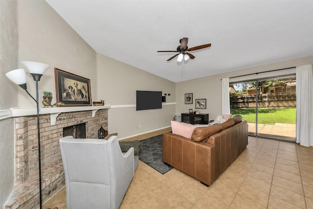 living room featuring vaulted ceiling, light tile patterned floors, ceiling fan, and a fireplace