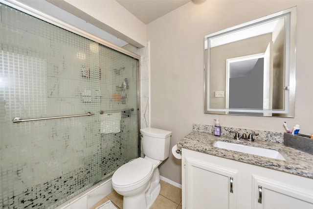 bathroom with an enclosed shower, vanity, tile patterned floors, and toilet