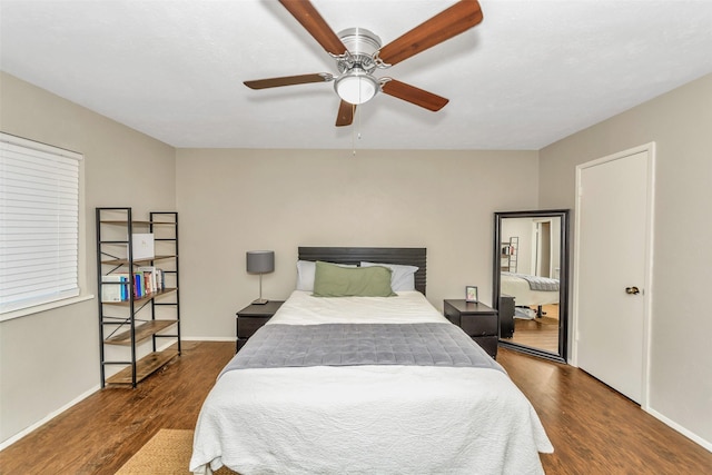 bedroom with dark hardwood / wood-style floors and ceiling fan