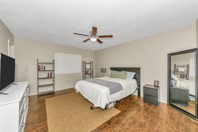 bedroom with ceiling fan and dark hardwood / wood-style flooring