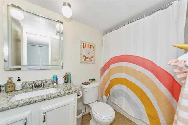 bathroom featuring vanity, curtained shower, and toilet