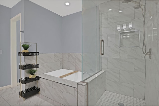 full bathroom featuring a stall shower and a garden tub